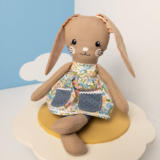 Handcrafted stuffed animal hare Fleur wearing removable Liberty London floral fabric dress with posable arms